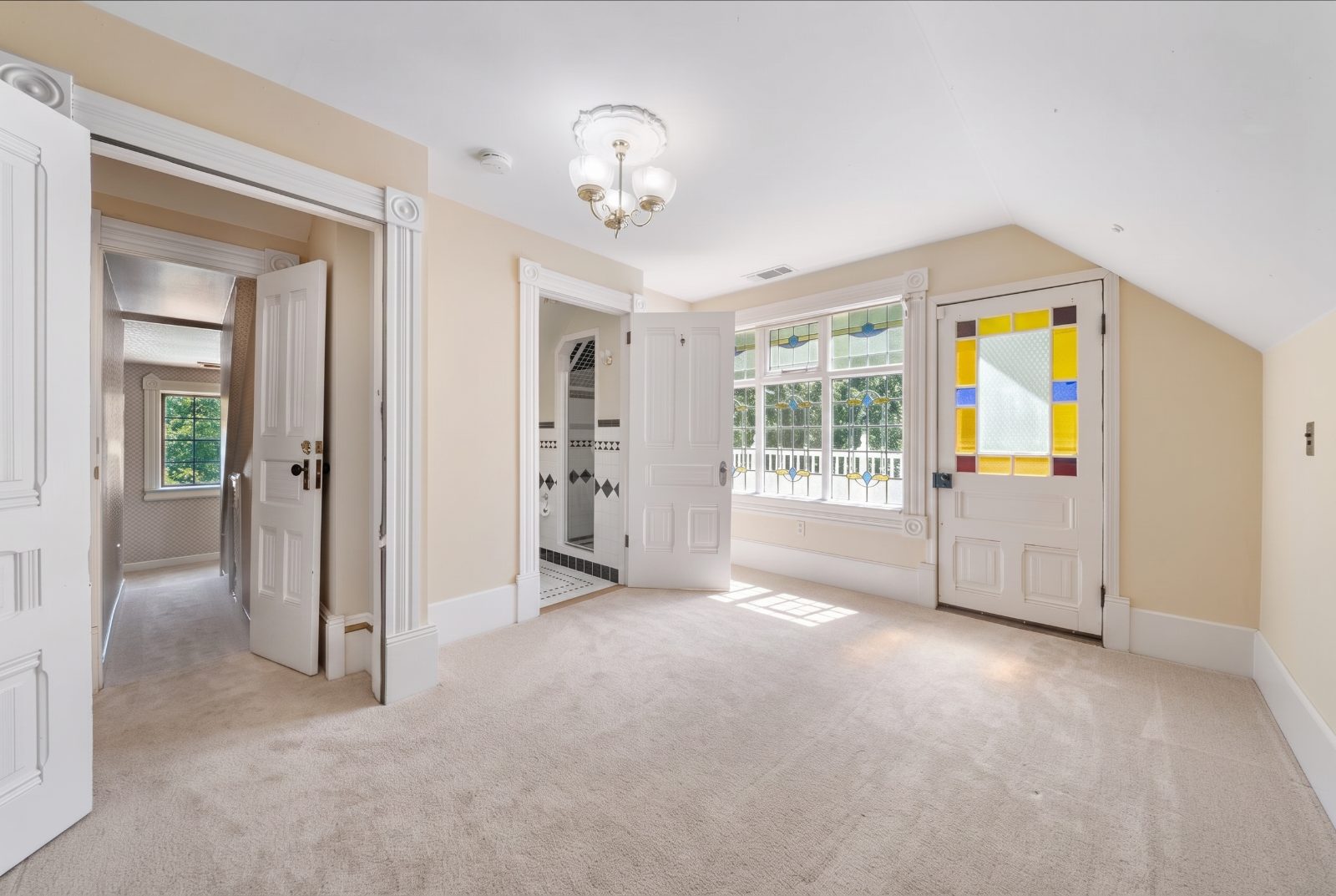 Upstairs landing with stained glass door and adjoining bath