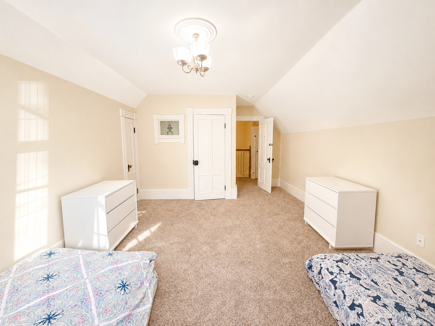 Bedroom with vaulted ceiling, twin beds, and dormer window
